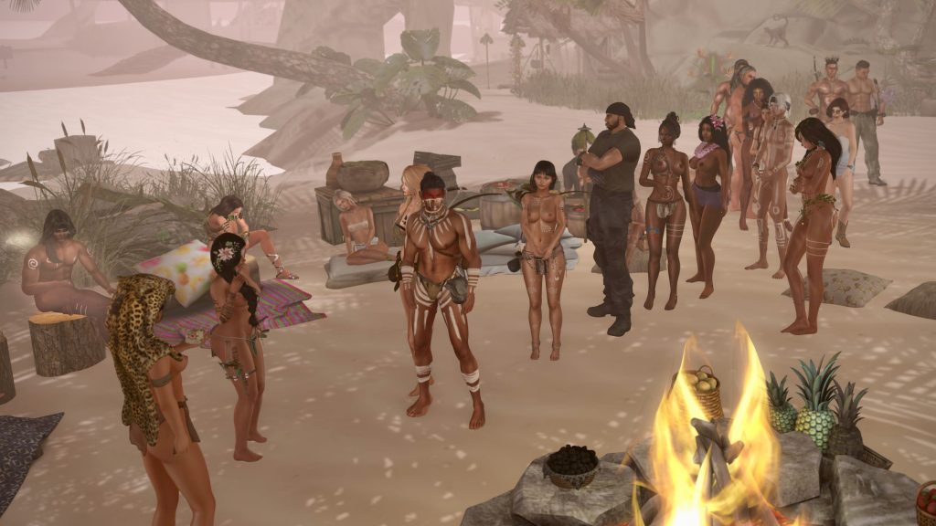 A group of men and women gather around a beach bonfire, some adorned with tribal attire and body paint, set against a tropical backdrop