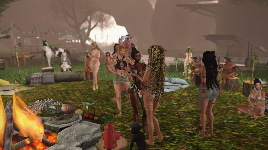 Villagers gather by a fire, sharing drinks and conversation in the jungle camp