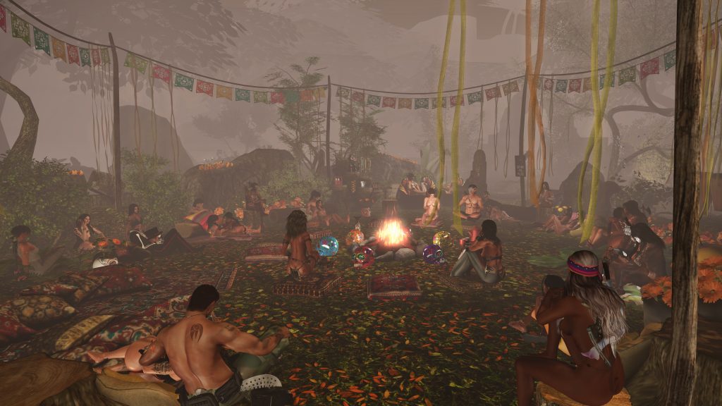 People gather around a central fire at a jungle camp under colorful banners