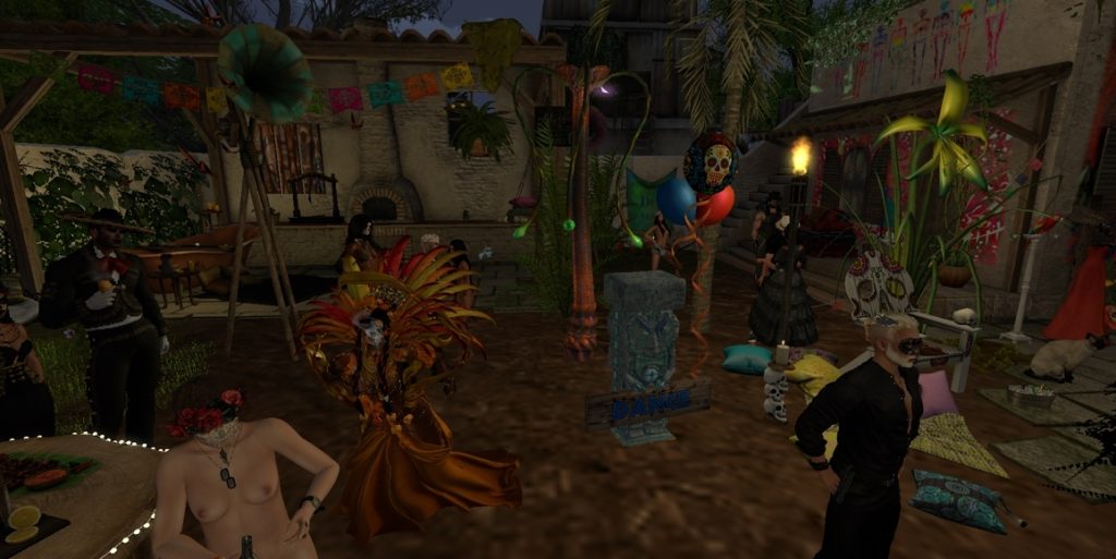 Topless native woman holds a drink while dancers celebrate in the jungle camp