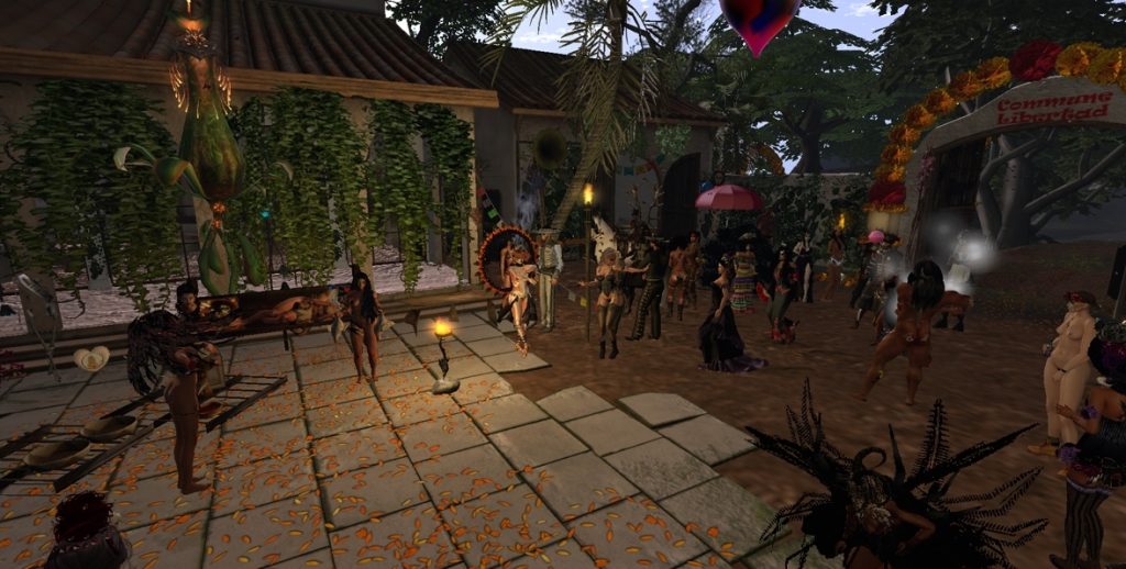 Gathering of villagers in diverse costumes celebrate under decorated arch in jungle camp