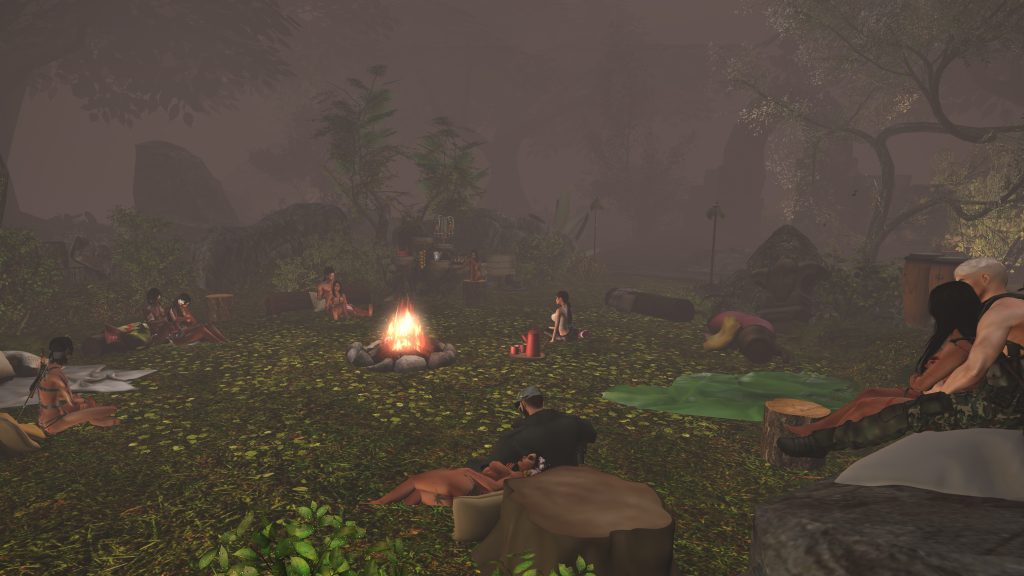 Villagers gather around a campfire in the jungle clearing, relaxing and talking