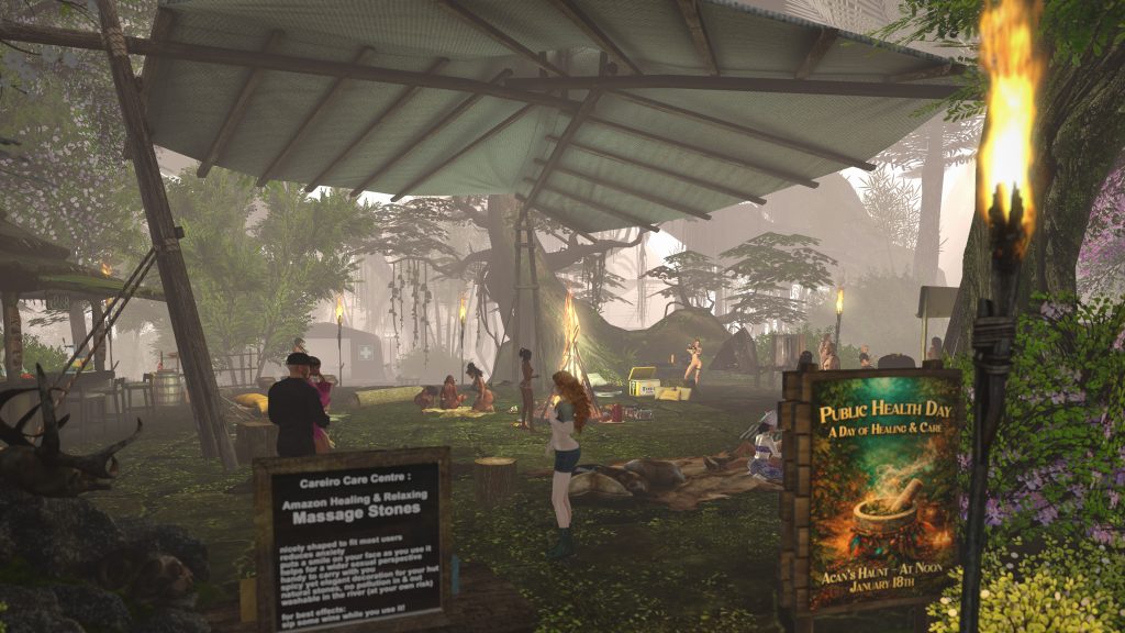 Villagers gather around a fire under a shelter during a health day event in the jungle camp