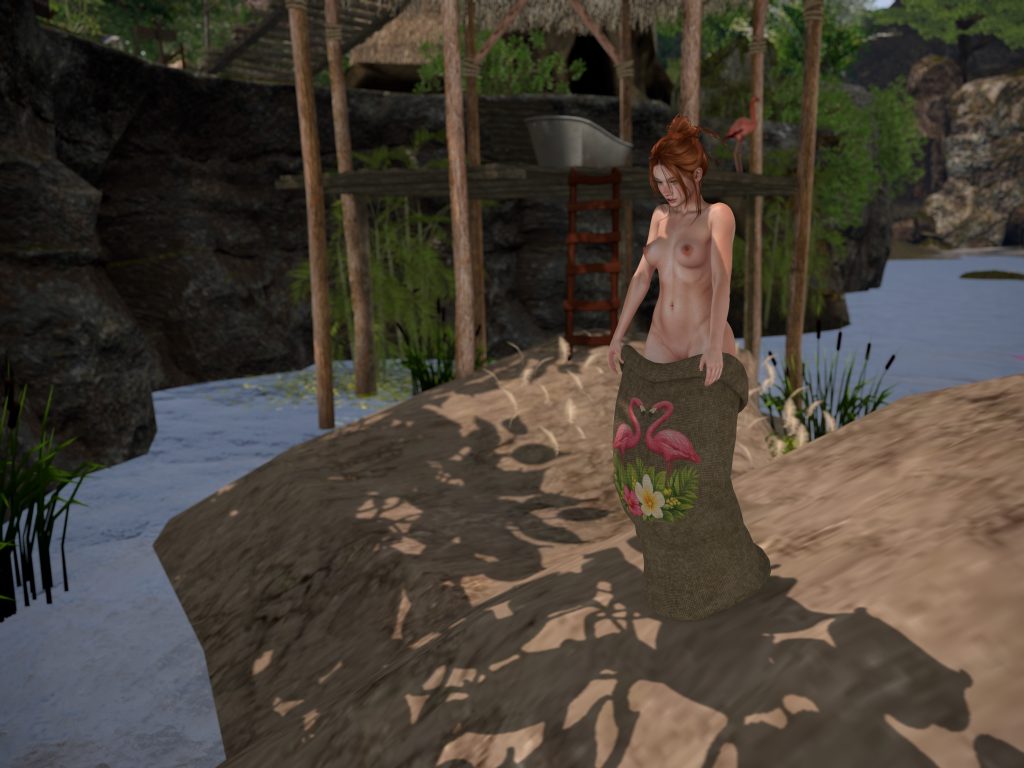 Native woman topless lifts a patterned sack around her hips while standing on the riverbank