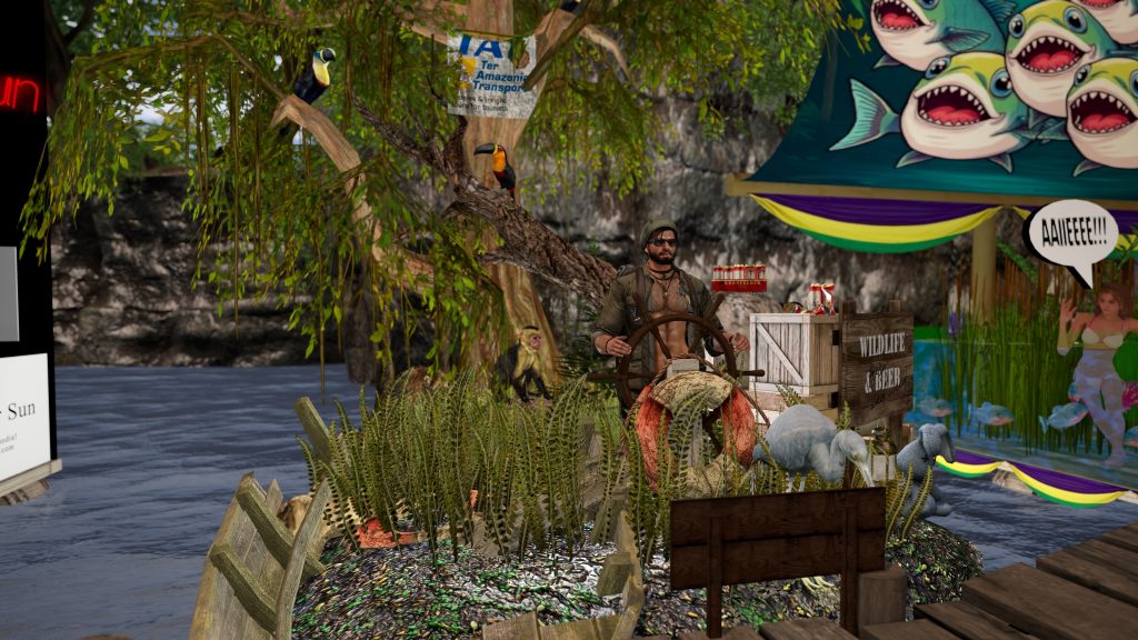 Shirtless villager steers a wooden wheel at the riverbank camp