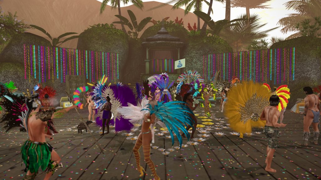 Dancers in colorful feather headdresses perform on a confetti-strewn wooden stage in the jungle camp