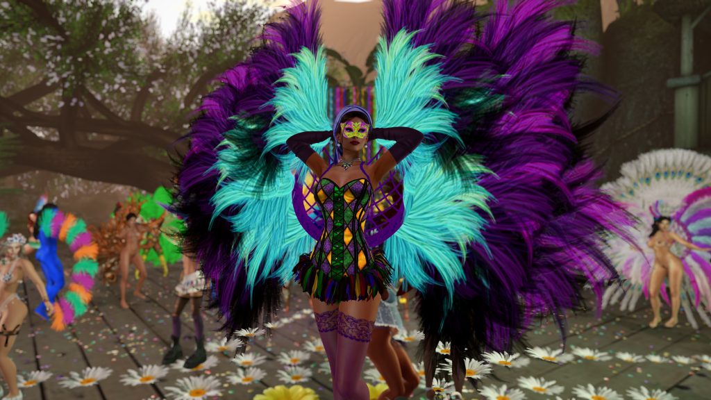 Native woman in a corset and feathered wings adjusts her mask on the jungle camp stage