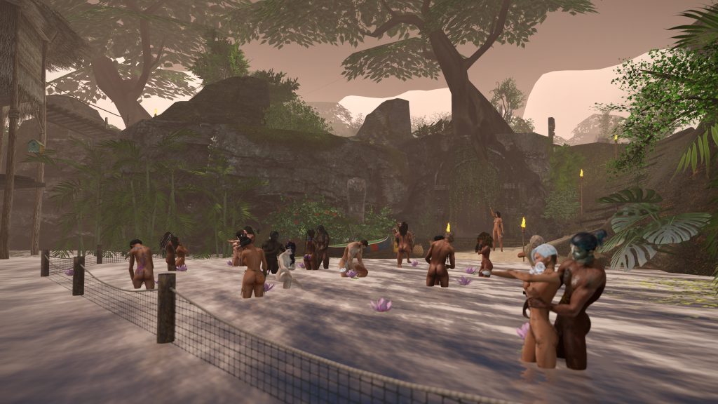 Unclothed villagers wade and kneel in a shallow river at the jungle camp during a dusk ritual