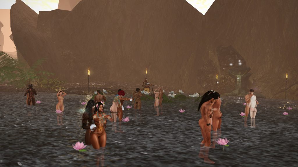 Villagers topless wade among lotus flowers at a ritual pool beneath rocky cliffs by torchlight