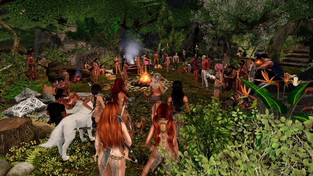 Topless dancers circle a fire in the jungle camp