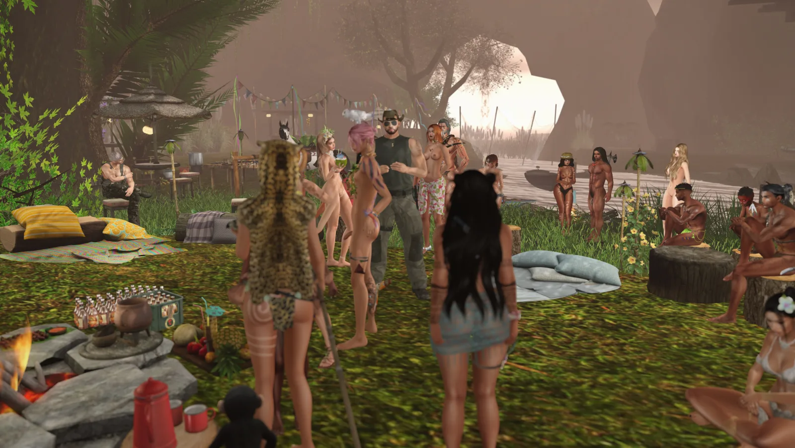 Group gathers by fire in jungle camp, some topless, others in attire, as evening falls on the riverbank setting