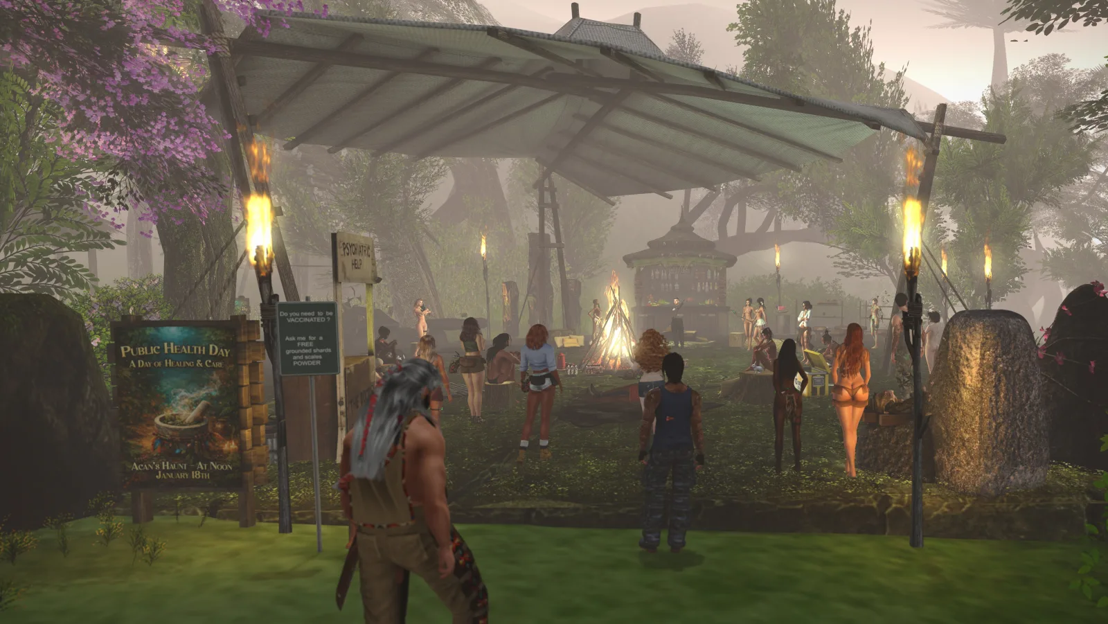 A group gathers around a bonfire under a canopy in the jungle camp for a healing ceremony