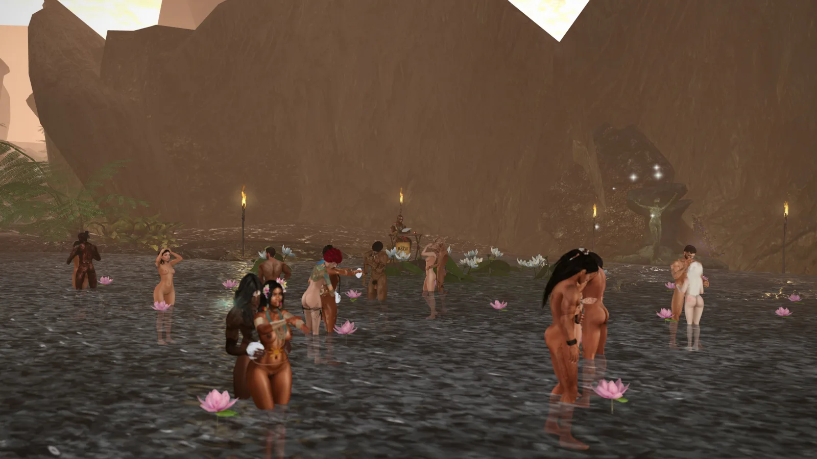 Villagers topless wade among lotus flowers at a ritual pool beneath rocky cliffs by torchlight