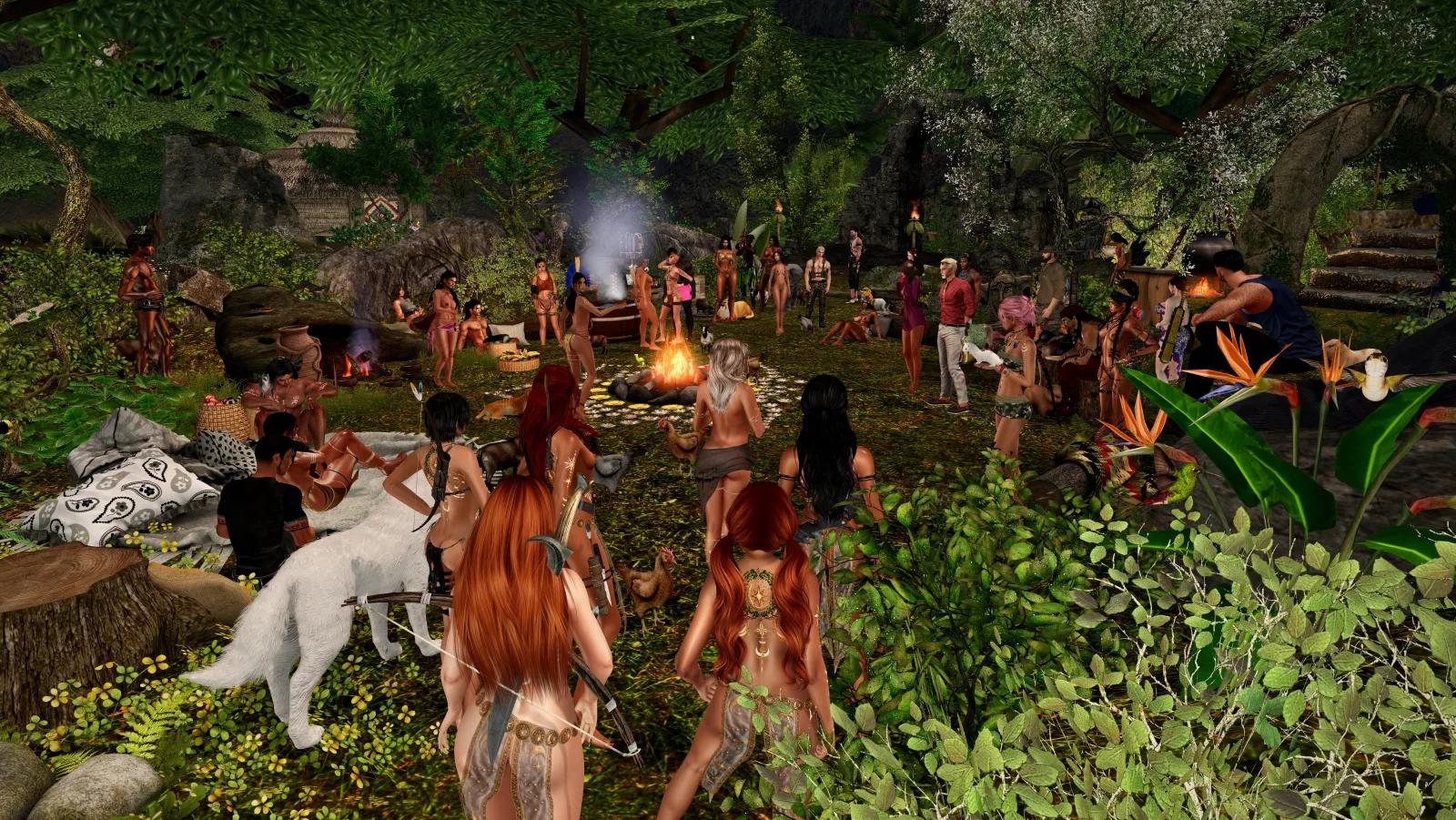 Topless dancers circle a fire in the jungle camp